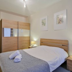 master bedroom with double bed and wardrobe storage in madou brussels
