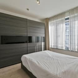 riverside two bedroom apartment master bedroom with double bed and wardrobe