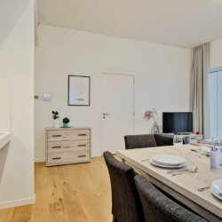 dining table and living room with cable television in bbf serviced apartment antwerp