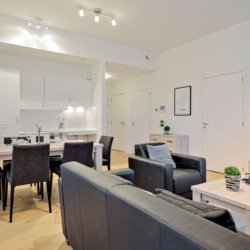 sofa and coffee table with cable television in bbf serviced apartment antwerp
