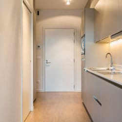 entrance and fully equipped kitchen with washing machine in studio apartment near brussels international airport