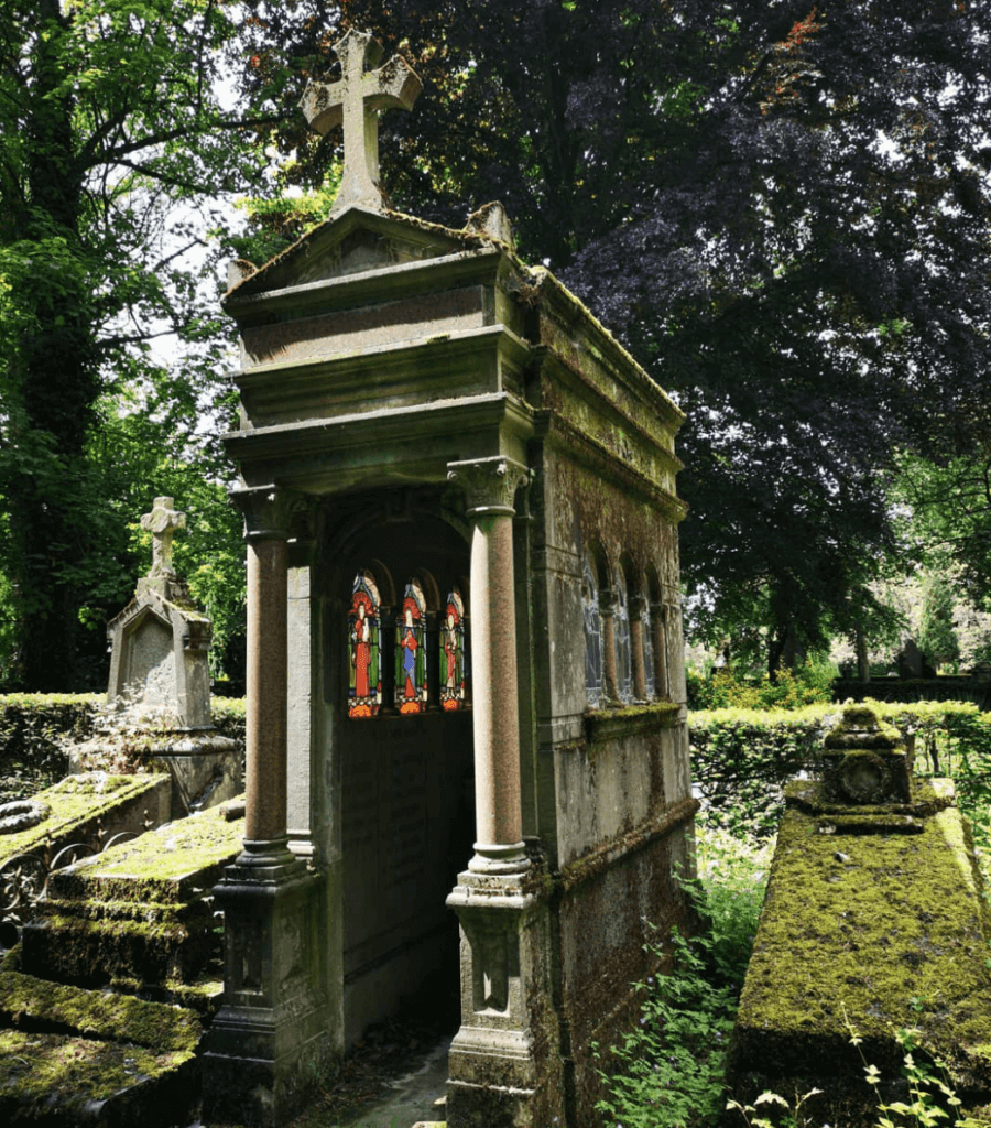 beautiful old graves in the brussels cemetery with stain glass windows