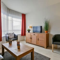 cable tv and sofa chairs in one bedroom bbf apartment