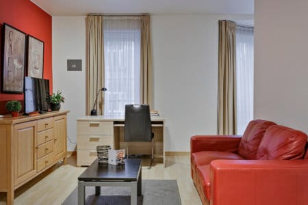 living room with office work desk and cable television in european quarter