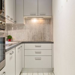 fully equipped kitchen with oven and microwave