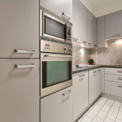 fully equipped kitchen with oven and microwave