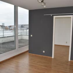 unfurnished studio apartment in south brussels balcony view living space and bedroom entrance