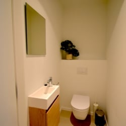 A clean and modern toilet in a furnished apartment